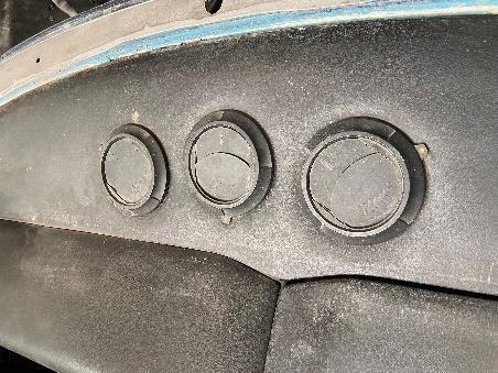 The exposed window aperture above the dashboard, with a strip of lighter blue paint visible along its edge.